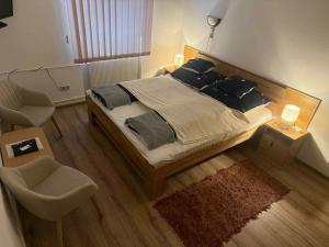 a bedroom with a large bed and a chair at Park Hédervár in Hédervár +31 photos