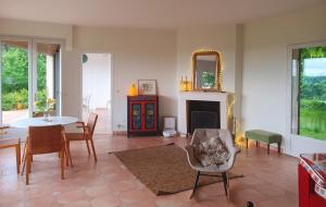 a living room with a table and a fireplace at Petit Vaure in Ruch