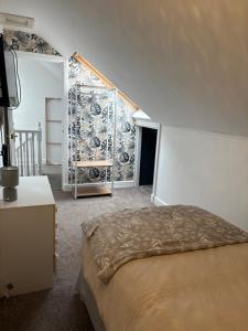 a bedroom with a bed and a wall at Anglesey quiet cottage milton in Gwalchmai