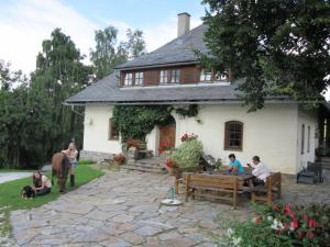 a group of people sitting in front of a house at Familienbauernhof Gunzer-Sank in Eberstein