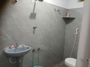 a bathroom with a sink and a toilet at Param Homestay in Pondicherry +55 photos