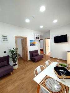 a living room with a couch and a table at Leonidio Downtown Haven in Leonidion