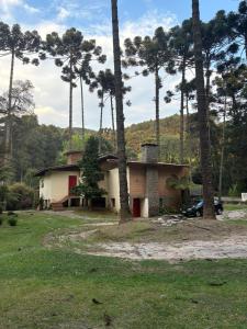 a house with a car parked in front of it at Recanto Bellagio in Campos do Jordão