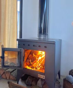 a stove with a fire inside of it at Lalau Casa de Playa in Chapadmalal