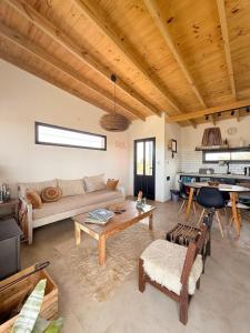 a living room with a couch and a table at Lalau Casa de Playa in Chapadmalal