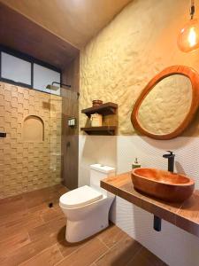 a bathroom with a wooden sink and a toilet at Hotel Quincha y Adobe in Huanchaco +91 photos