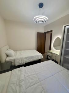 a hospital room with two beds and a mirror at zayed in Sheikh Zayed