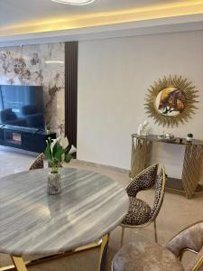 a dining room with a table and chairs and a mirror at zayed in Sheikh Zayed +17 photos