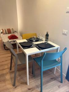 ブッソレンゴにあるMini Apartment - Verona&Lakeのワイングラス付きのテーブルと椅子