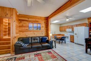 a living room with a leather couch and a kitchen at Misty Mornings Escape in Boone