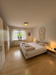a bedroom with a large bed and a window at 95qm Wohnung für 6, 3 Schlafzimmer, ruhig & stadtnah, Parkplatz in Bad Hersfeld