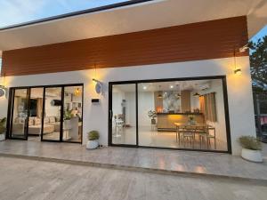 a house with large glass doors and a living room at ต้นจันทร์เรสซิเดนซ์ in Chaweng