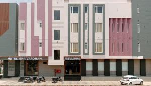 a building with many different colored doors on it at Hotel Shrivardhan in Sūratgarh