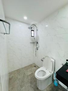 a white bathroom with a toilet and a shower at Patong Elite Condo Nanai, Patong, Phuket in Patong Beach