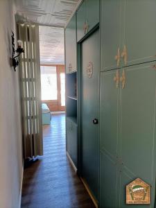 a hallway with green lockers in a room at Dal Buffo Gufo in Pila +16 photos