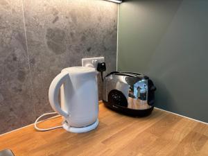 a toaster sitting on top of a wooden table at Bedford Guesthouse in Liverpool