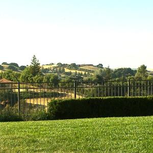 een hek voor een veld van groen gras bij A Villa with extraordinary views in Solvang