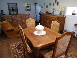 a dining room with a wooden table and chairs at Maïstine in Dancevoir