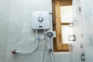 a shower in a bathroom with a white tank at O'Reilly's Bungalow in Negombo +40 photos