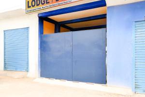 a blue garage door on the side of a building at OYO Flagship Hotel O Mo Kudia in Puri +56 photos