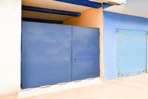 a large blue garage door on a building at OYO Flagship Hotel O Mo Kudia in Puri