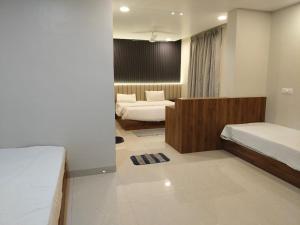 a hotel room with two beds and azeb sidx sidx sidx sidx sidx at RadhaKrishna Executive in Tuljapur