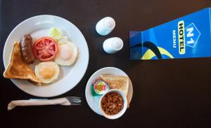 a plate of breakfast food with eggs sausage and toast at N1 Hotel Bulawayo in Bulawayo