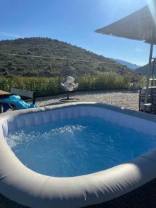 a bird is standing next to a hot tub at Lago Calmo Villa in Ksamil