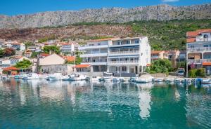 a group of boats docked in a marina at Apartments Duje in Dugi Rat