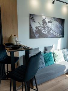 a living room with a table and a couch at Apartamenty 3 Maja in Płock