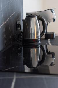 a black tea kettle hanging on a kitchen counter at Somma Relax Apartment in Sommacampagna