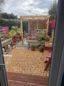 a garden with a bench and a gazebo at Julara in Deganwy