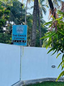 a sign on top of a white fence at The Grace Cottage - Negombo in Dagonna +82 photos