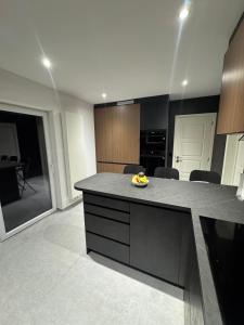 a kitchen with a island with a bowl of fruit on it at Villa Brussel in Dilbeek