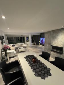 a large living room with a table and chairs at Villa Brussel in Dilbeek