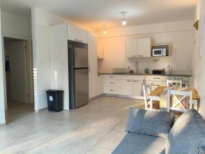 a kitchen with a couch and a table in a room at אורן בשדה in Sede Ilan