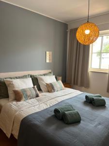 a bedroom with two large beds with pillows on them at Cabanas De Miramar in Tavira