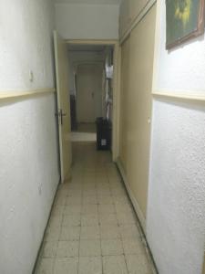 an empty hallway with a hallway leading to a room at Bouchaoui 