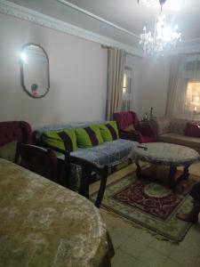 a living room with a couch and a table at Bouchaoui 