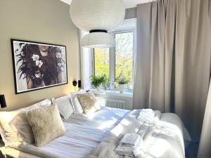 a bedroom with a bed and a large window at Västerhöjdsgården in Skövde