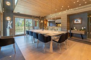 a large dining room with a long table and chairs at Chalet Le Nolde in Mussillon +63 photos