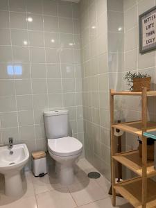 a bathroom with a toilet and a sink at Cabanas De Miramar in Tavira +24 photos