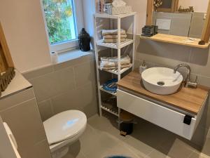 a bathroom with a white toilet and a sink at Ferienwohnung am Schlosspark in Potsdam