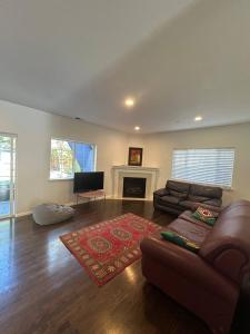a living room with a couch and a fireplace at Olive Startup House Menlo Park in Menlo Park