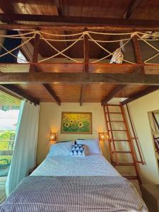 a bedroom with a bunk bed with a ladder at Chalé Adventure - Serra de São Bento RN in Serra de São Bento