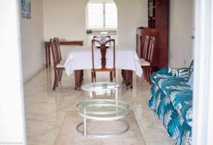 a living room with a table and a couch at Castles in Paradise 2bd Apt C3 by ZenBreak in Rouarné