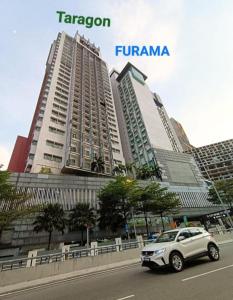 a car parked in front of a large building at The Grand Residence in Dhaka