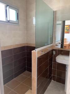a bathroom with a shower and a sink and a mirror at Panorámico de esquina in Tetouan +41 photos