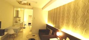 a room with a couch and a living room with a wall at The Grand Residence in Dhaka +82 photos