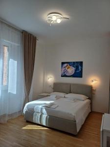 a bedroom with a large bed and a window at Orchidea Stazione in Bologna